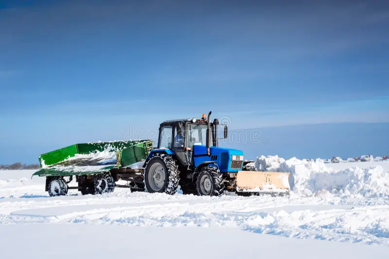 blue tractor trailer cleans snow shovel road 109841492